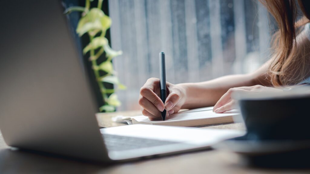 female hand writing notes