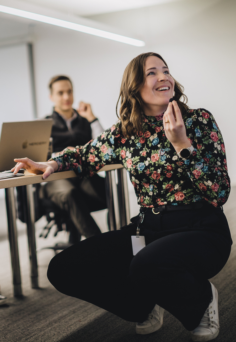 Woman smiling and talking into a small microphone