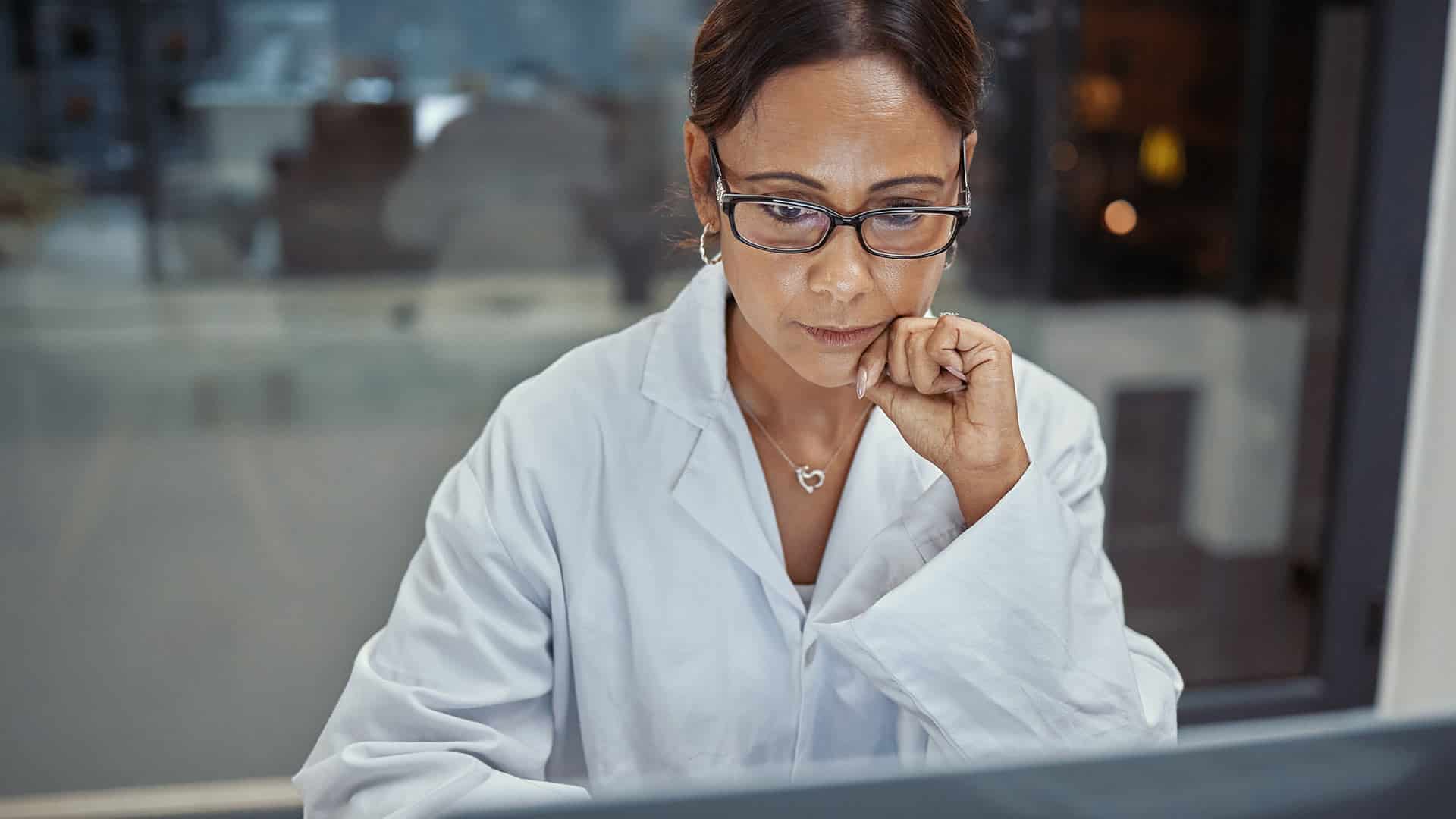 Woman scientist working in a lab at a laptop